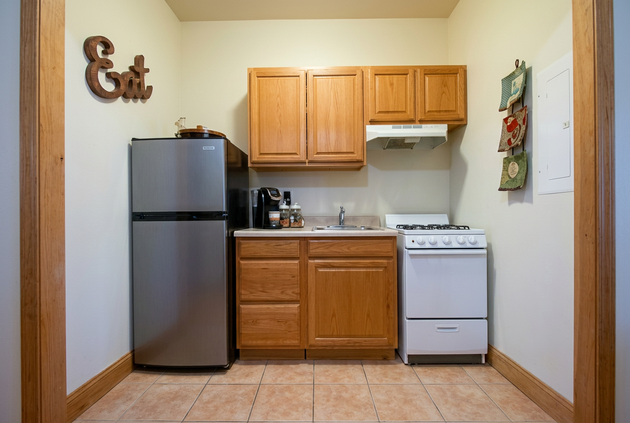 Full kitchen with gas range, fridge, and wood cabinetry