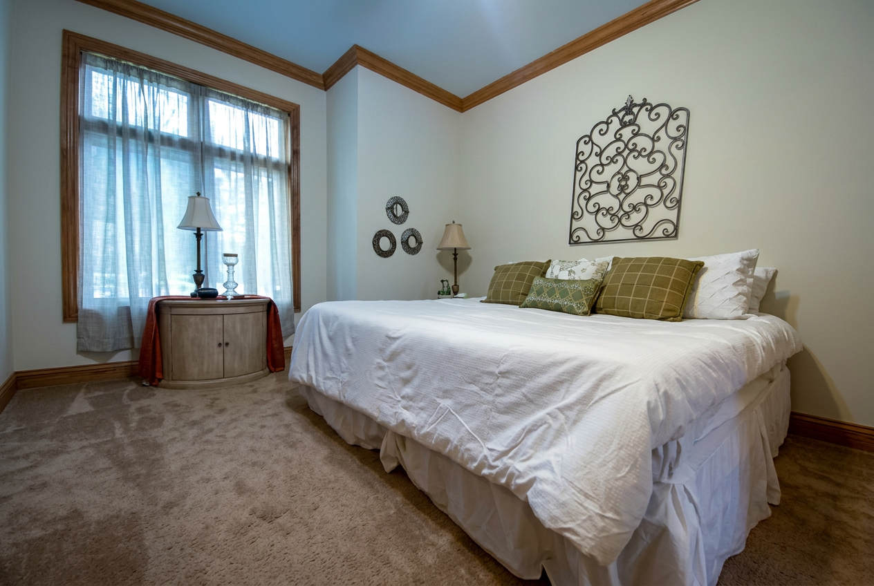 Main bedroom with queen bed and vaulted trim
